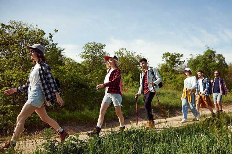 a group of students hike down a path