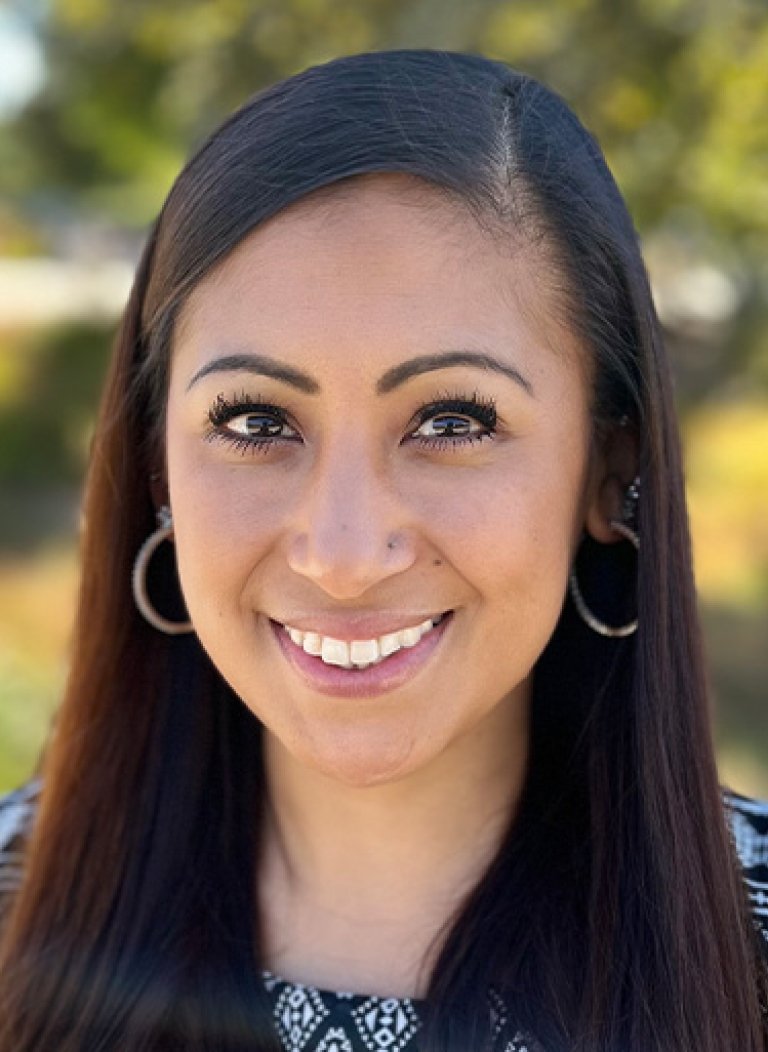 Close-up of Steffanie Guillermo with long straight dark hair and wearing a black and white top