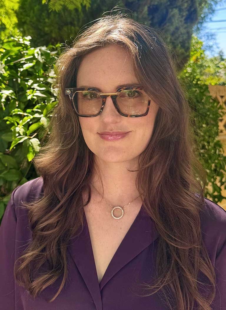 headshot of leah senatro wearing glasses and a dark purple blouse