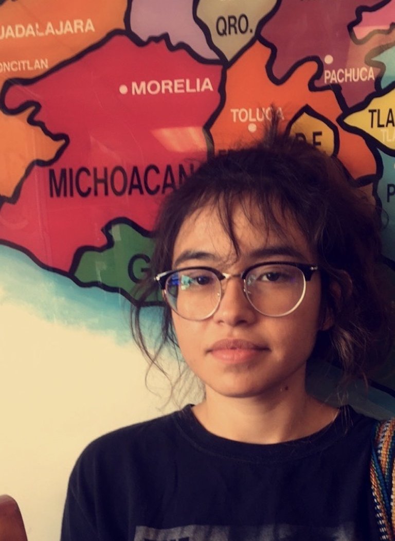 Professor Debbie Duarte standing in front of a map