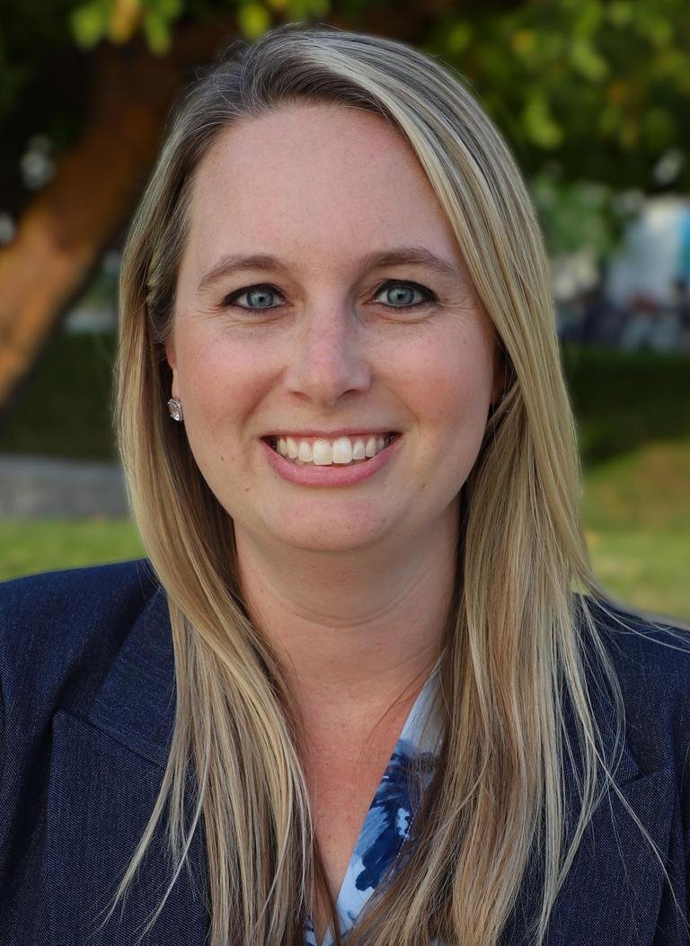 Woman in blue blazer with long blonde hair.  