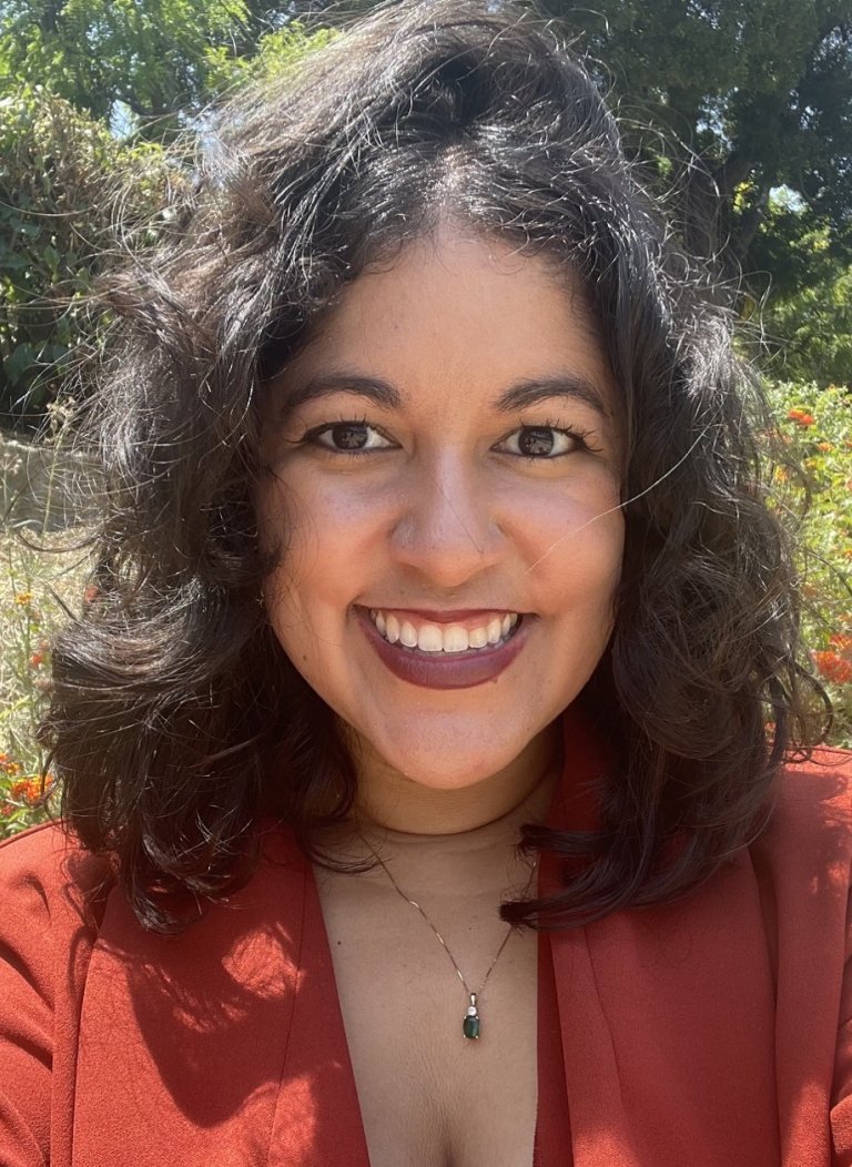 Andrea Acosta with plants in the background