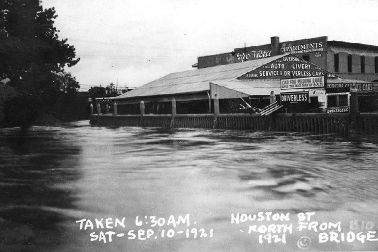 A monochromatic photo of a flooded street.