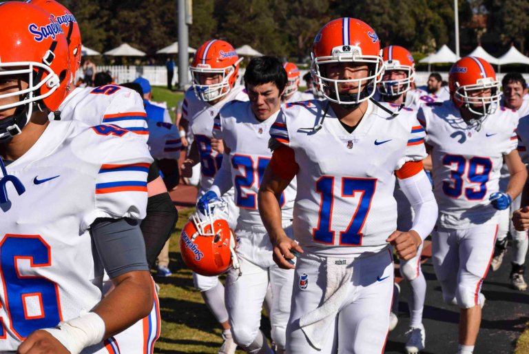 Sagehen football players take the field