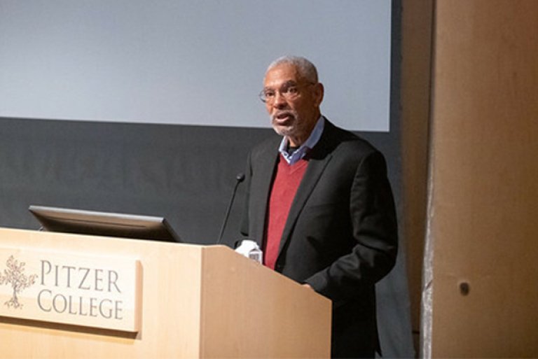 Melvin L. Oliver stands at the podium in Pitzer's Benson auditorium.