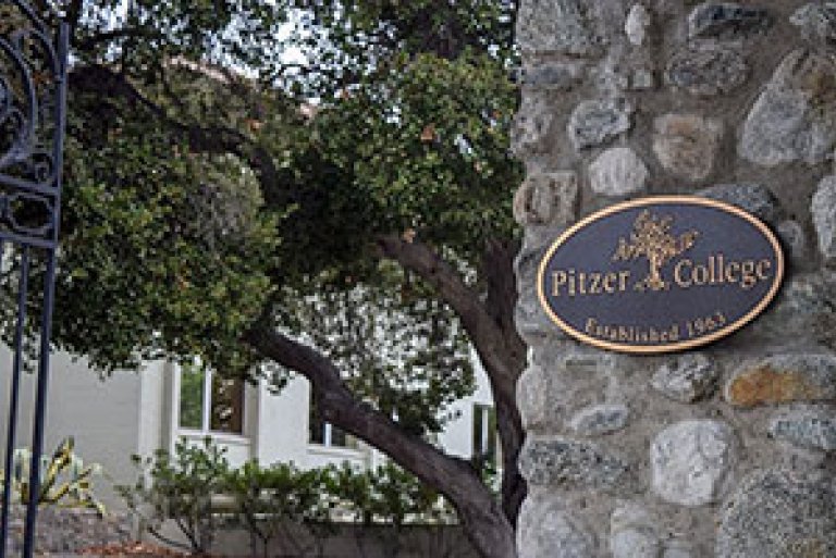 view of the pitzer gate and bronze plaque at the college's entrance