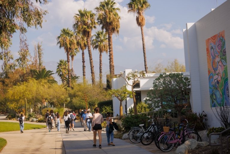 Wide campus view of people walking.