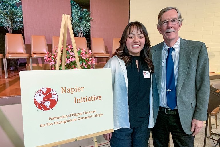 Natasha Yen stands with her mentor Paul Cromwell at the Napier Award ceremony. To their right is a sign that says Napier Initiative.