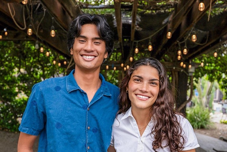 Sammy Basa and Zhane Moledina stand together under the leafy green canopy of Pitzer’s Grove House Outdoor Classroom.