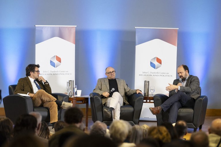 Phil Zuckerberg sits on a stage with two guests