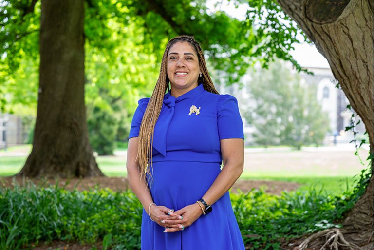Danielle Lynch stands in front of a field at Pomona College