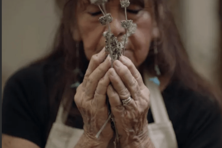 Barbara Drake holding native plants