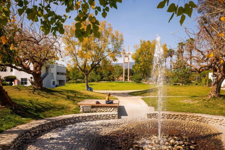 a student sits near the pitzer fountain