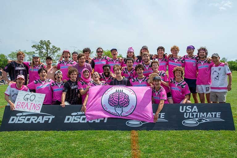 the braineaters team pose with their team banner on a field