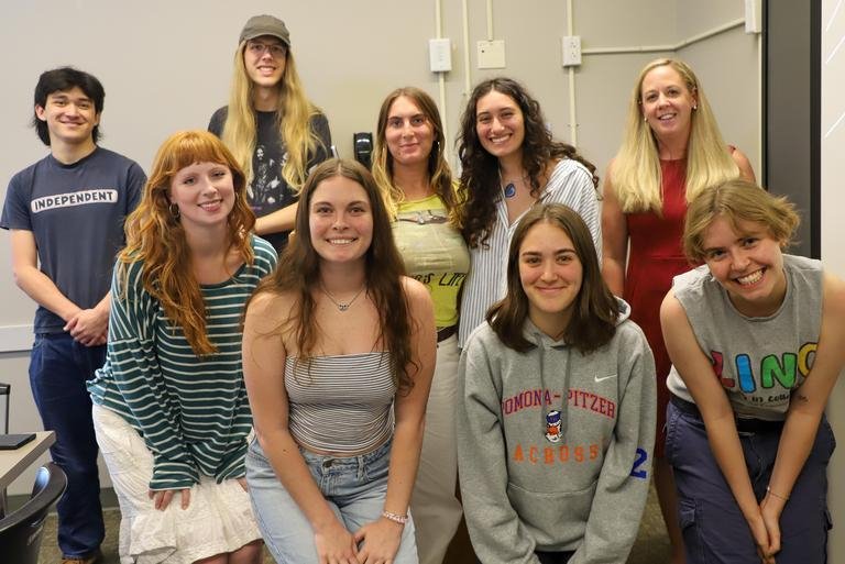 Professor Amanda Lagji poses with a group of students that collaborated with her on her book