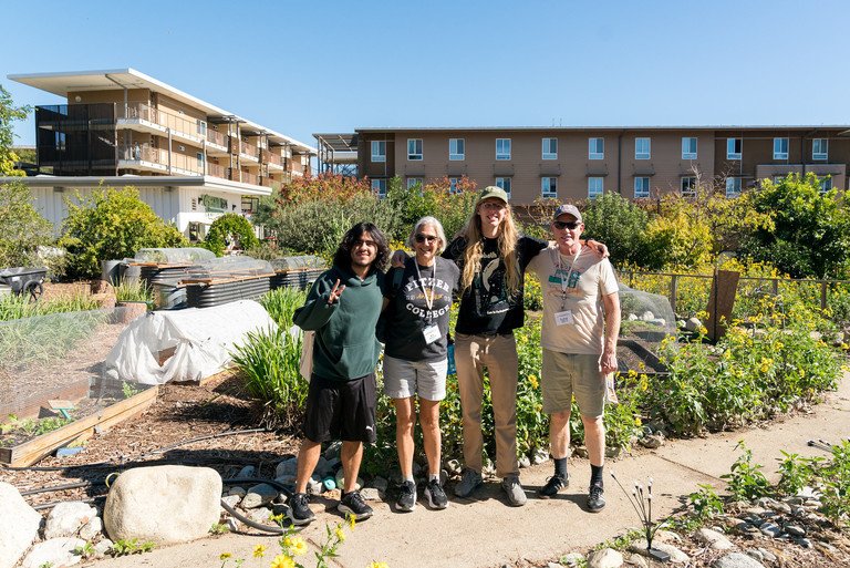 a family stands together in the student garden