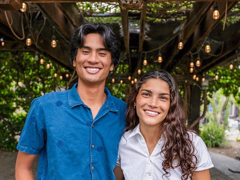 Sammy Basa and Zhane Moledina stand together under the leafy green canopy of Pitzer’s Grove House Outdoor Classroom.
