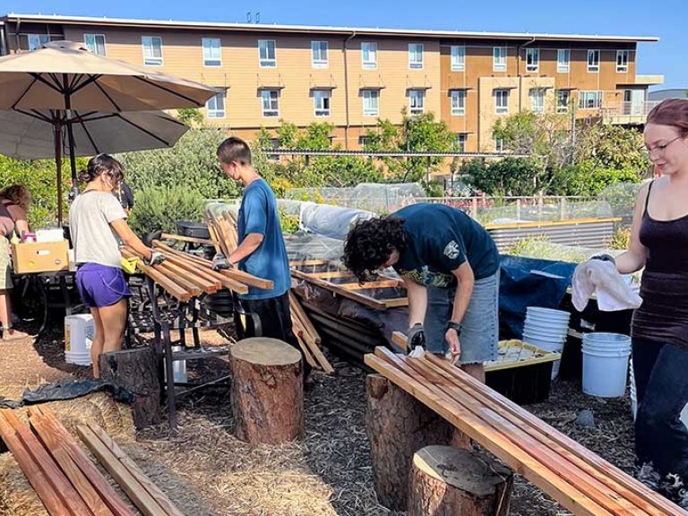 Pitzer students work in the student garden on Earth Day