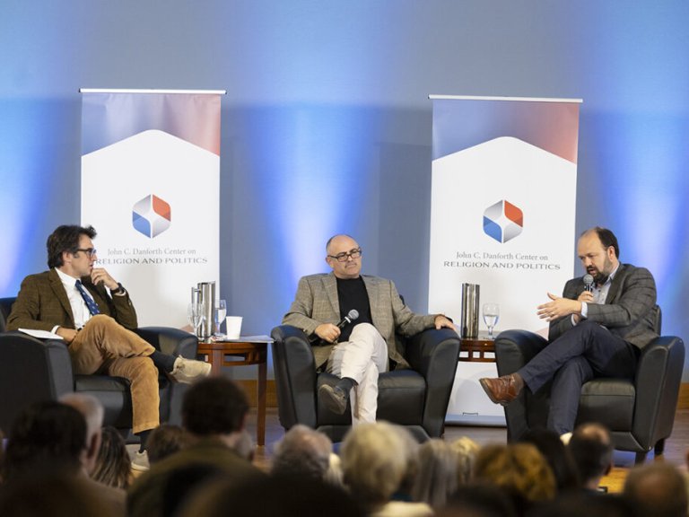 Phil Zuckerberg sits on a stage with two guests