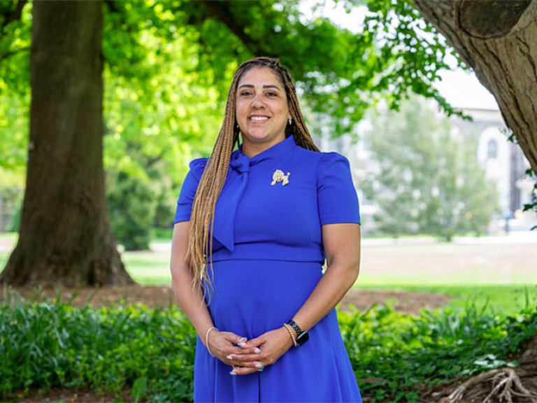 Danielle Lynch stands in front of a field at Pomona College