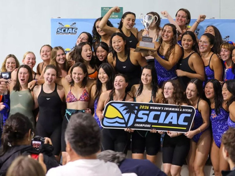 the women's swim team pose with the 2026 SCIAC champions sign