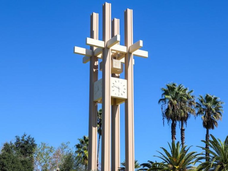 the pitzer clock tower against a blue sky