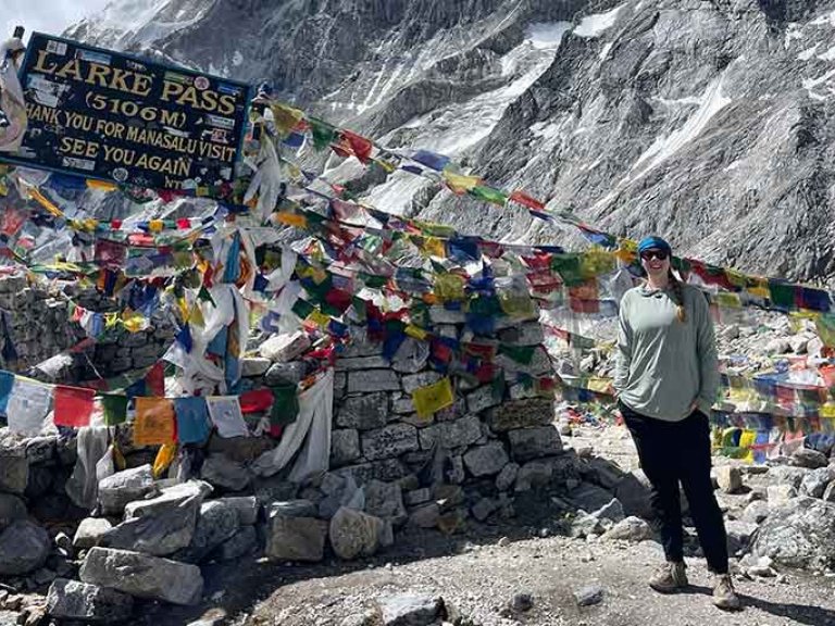 student stands at Larke Pass in Nepal