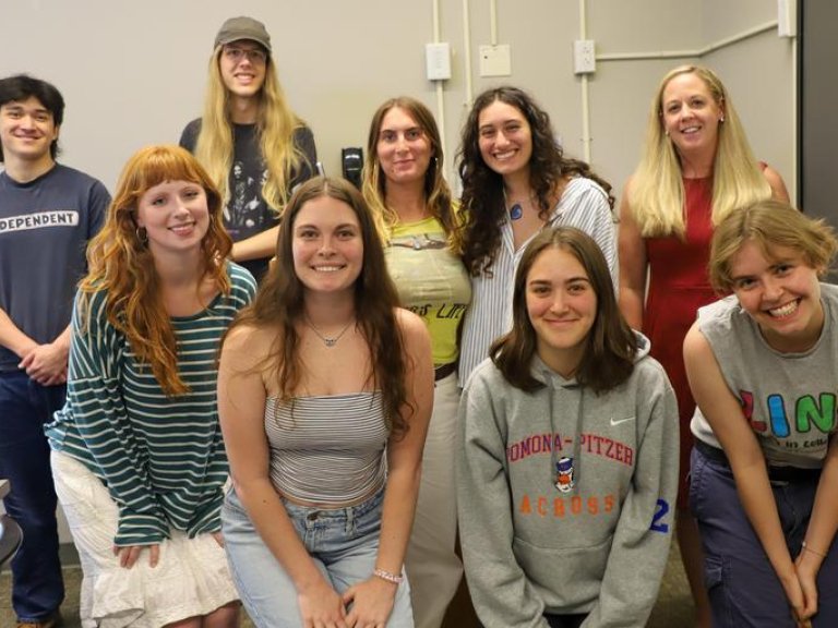 Professor Amanda Lagji poses with a group of students that collaborated with her on her book