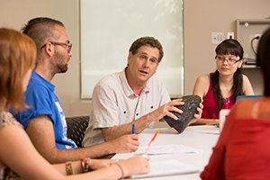 A photo of Paul Faulstich with students.