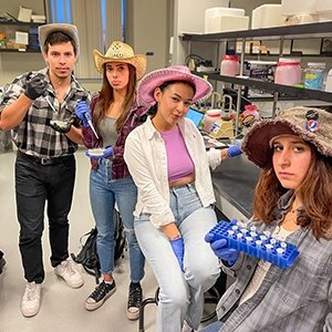 Bertha M. Posada Villanueva, Daniel Bonilla, Sophia Lore, and McKayla Khatija Proulx in a science lab.