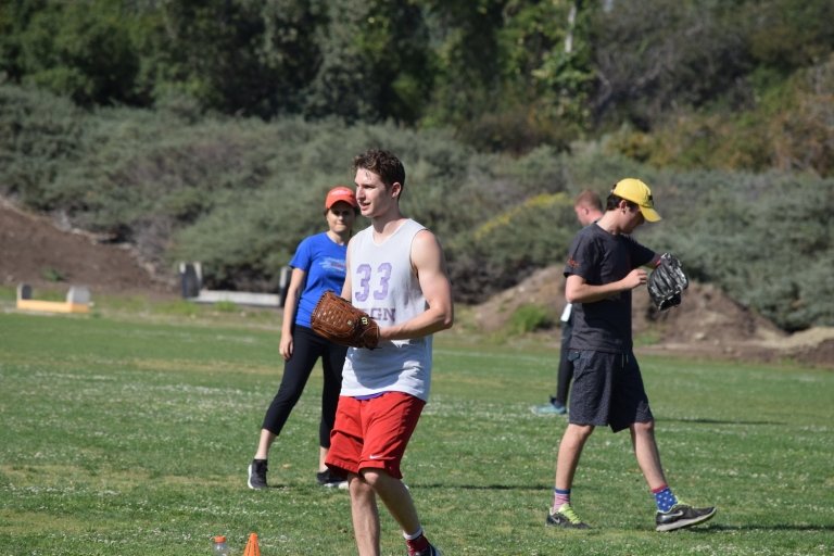 Pitzer students change sides during a softball game