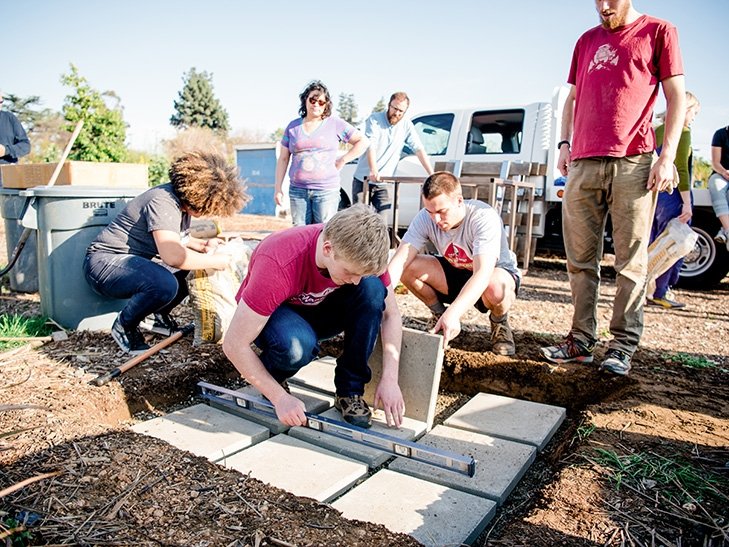 students help landscape at huerta del Valle community garden