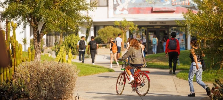 Pitzer College students walking and biking through center of campus.