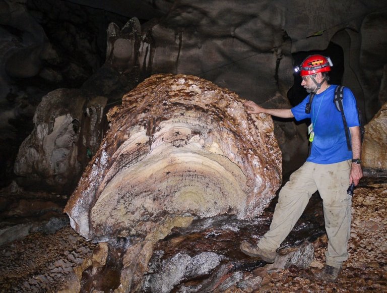 Professor Don McFarlane inspects a boulder inside Niah Cave in Borneo