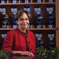 Muriel Poston sitting in front of life science background