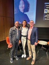 Tubbs, Ruett Foster, and Storm Thacker standing in front of projected screen at three mothers event