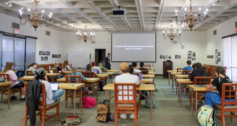 Students sit at their desks as they listen to Adam Romero's talk in the Founders Room.