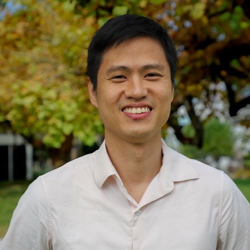 Closeup of Ahn Pan, who has short straight black hair and wears a white collared shirt.