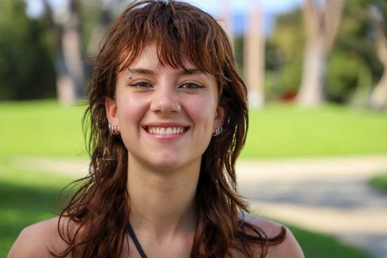 Andrea Robinowitz smiles at the camera while standing on the pitzer mounds.