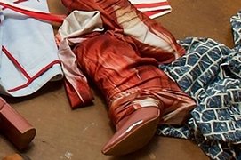 closeup of a pair of cowboy boots near strewn clothing