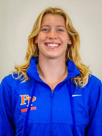 Valerie Mello has long wavy blond hair and wears a blue Pomona-Pitzer jacket.