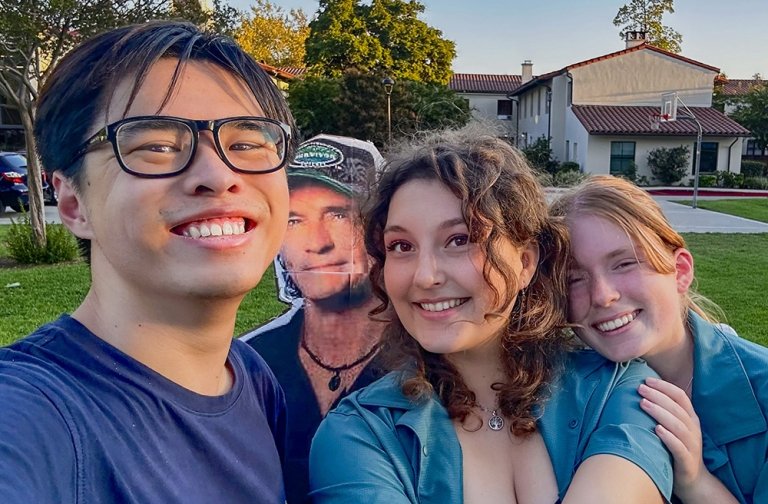 Students in the Claremont Survivor club pose with a cardboard cutout of Jeff Probst, the show's host