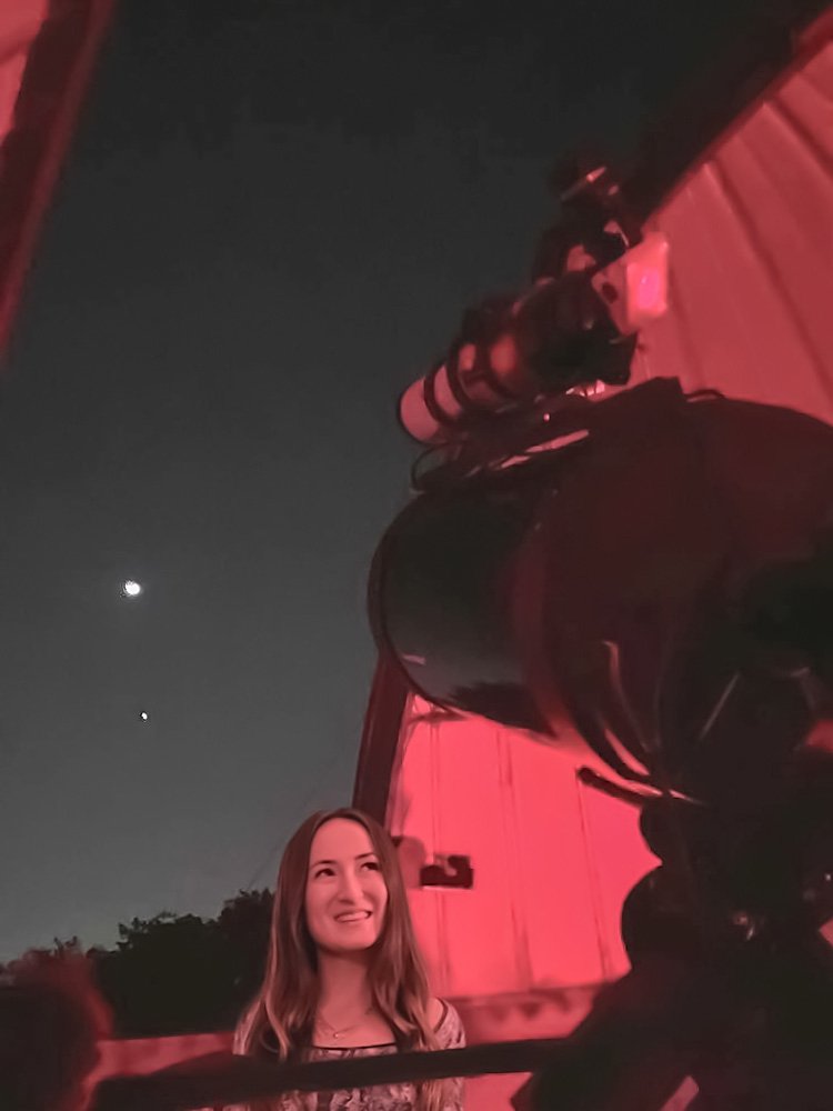 Scotia Rollins looks up at a telescope at the Pomona College observatory