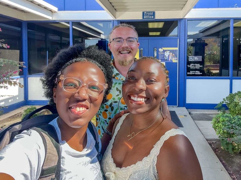 sia were, ramya Herman, and tim lewis pose in front of the san dimas high school main office