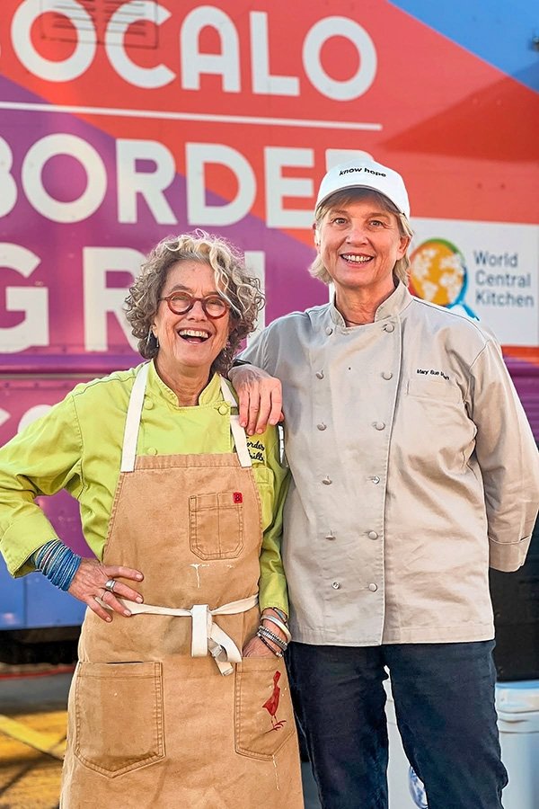Susan Feniger and Mary Sue Milliken in front of a World Central Kitchen food truck