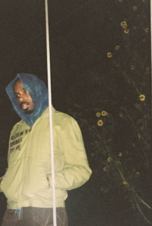 Marvin James wears a pale yellow jacket and a blue hood.