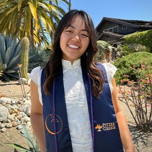 Close-up of Natasha Yen with long wavy dark hair and wearing a navy blue stole over a white top.