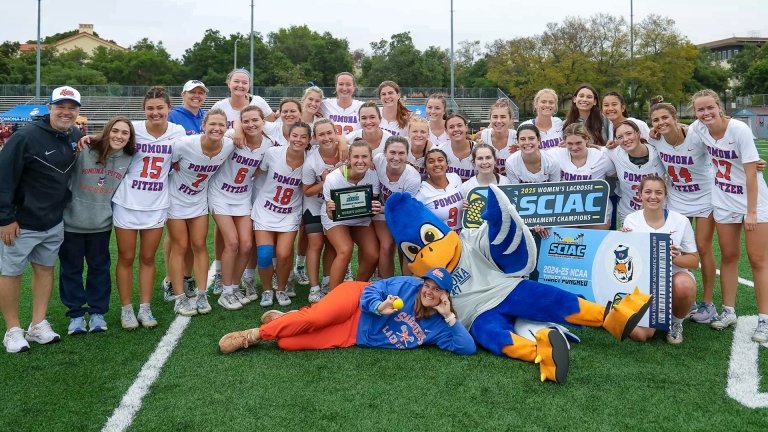 The Pomona Pitzer women’s lacrosse team stands with coaches and Cecil the Sagehen mascot with the SCIAC Tournament Championship banners and placard.
