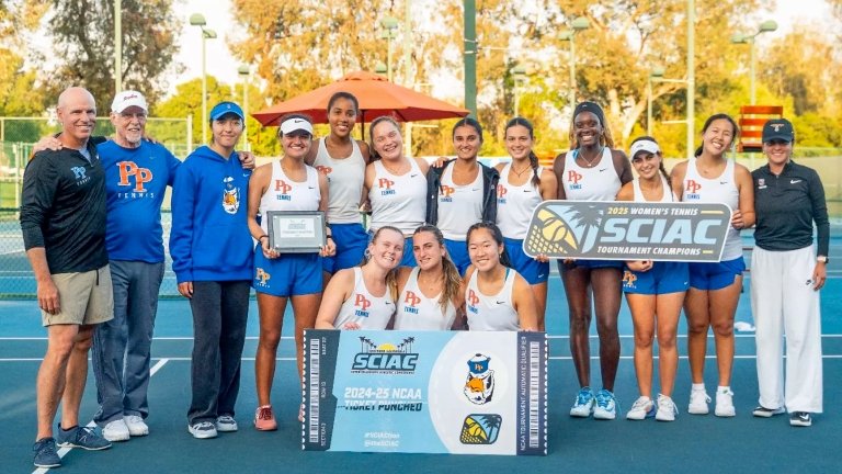 The Pomona-Pitzer women’s tennis team stand with their coaches on the tennis court and hold up the SCIAC Tournament Championship banners and certificate.