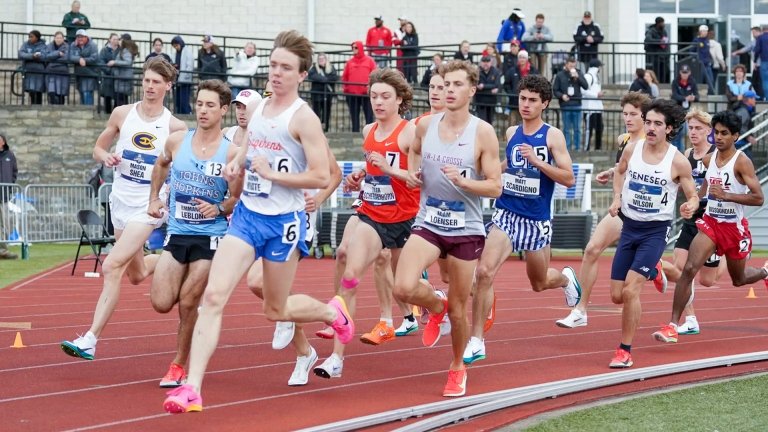 Various men’s track and field runners race each other on a track.